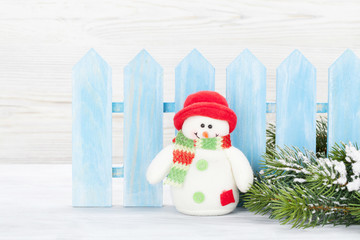 Christmas snowman toy and fir tree branch