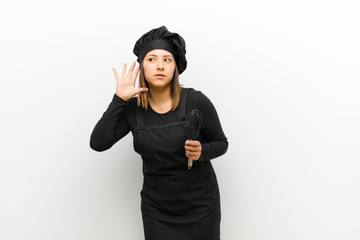 cook woman looking serious and curious, listening, trying to hear a secret conversation or gossip,...
