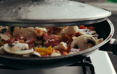 cooking pan, pasta with mushrooms, tomatoes, peppers, chicken