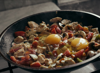 cooking pan, pasta with mushrooms, tomatoes, peppers, chicken