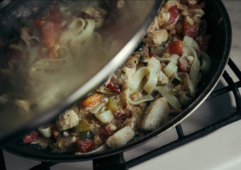 cooking pan, pasta with mushrooms, tomatoes, peppers, chicken