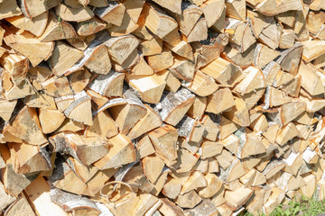 Dry chopped firewood lay in a pile on the street