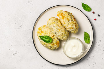 Healthy vegetable steamed rissoles with sour cream sauce.Top view, space for text.