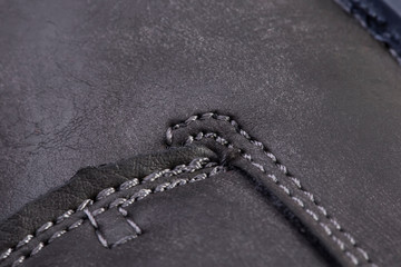 Part of a leather boot close-up. A fragment of the texture of leather shoes.