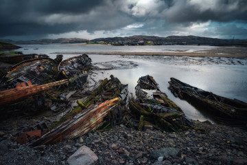 Abandoned ships cemetery at low tide near Teriberka village in Murmansk Region. Kola peninsula, Northern Russia