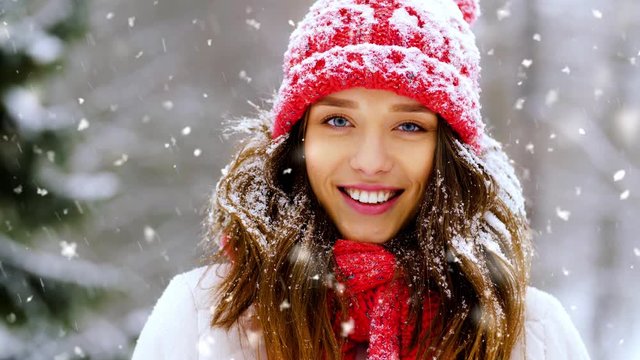 people, season and leisure concept - portrait of happy smiling woman outdoors in winter