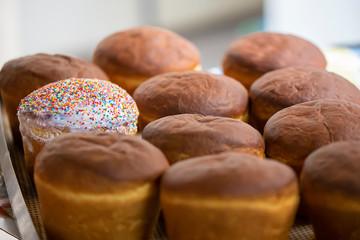 Industrial production of bread. Lots of baked goods on pallets. Freshly baked bun. Bakery