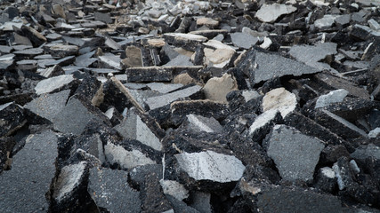 Background old cracked asphalt road scrap heap damage on the ground to be recycled.