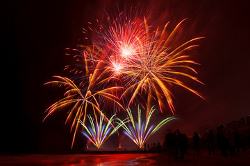 holiday fireworks of golden color on a black sky background