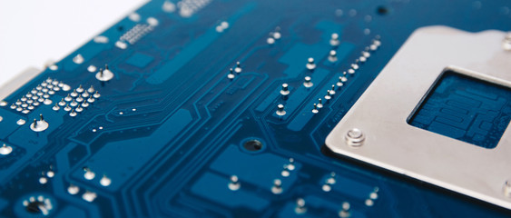 Electronic chip. Close up photo of blue PC circuit board.
