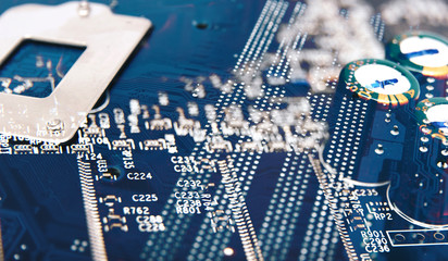 Electronic chip. Close up photo of blue PC circuit board. Abstract background.