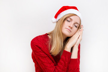 Beautiful woman wearing christmas hat over isolated background smiling doing sleep gesture with hand. Holiday concept. Emotion facial expression.