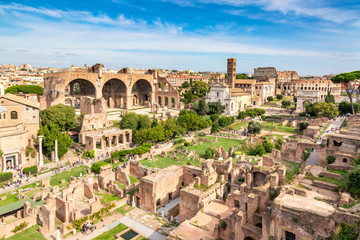 Aerial panoramic cityscape view of the Roman Forum and Roman Colosseum in Rome, Italy. World famous landmarks in Italy during summer sunny day. - obrazy, fototapety, plakaty