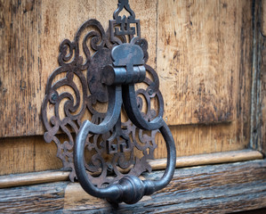 Ornate old, vintage Iron Door Knocker on old wood door