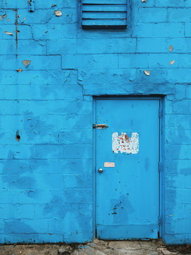 Direct view of blue wall with closed door