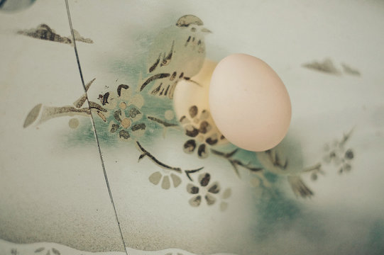 Close up view of egg placed on photo frame