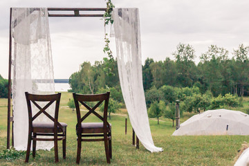 A natural wedding with a lake view. Rustic wedding decoration. Boho scenery.