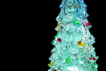 Led Christmas tree on dark background, copy space. Luminous glass xmas tree