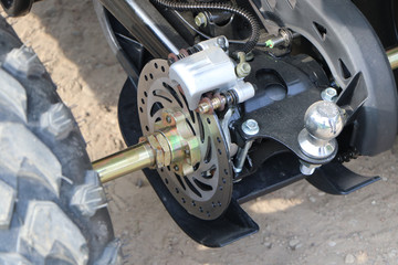 Clutch assembly and rear suspension of an ATV with a wheel and an exhaust pipe.