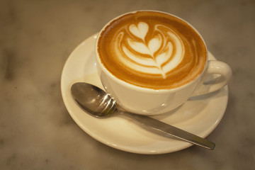 Beautiful served latte coffee in the cup