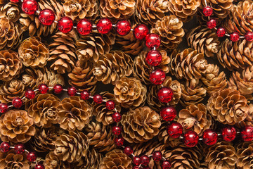 Background with pine cones and red garland