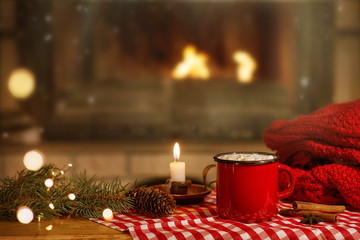 mug of cocoa with marshmallows near the fireplace at Christmas