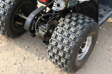 Clutch assembly and rear suspension of an ATV with a wheel and an exhaust pipe.