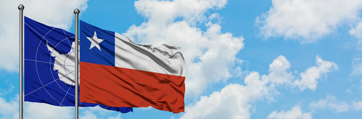 Antarctica and Chile flag waving in the wind against white cloudy blue sky together. Diplomacy concept, international relations.