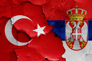 flags of Turkey and Serbia painted on cracked wall