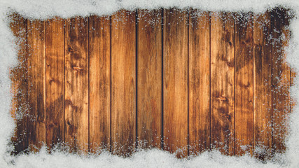 winter Background - Frame made of snow on wooden texture, top view with space for text