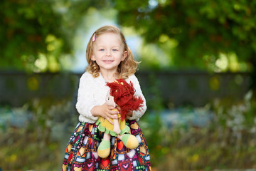 Cute little girl with a doll smiling