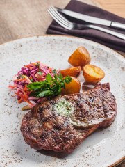 Beef steak with potato, salad cole slaw on the plate