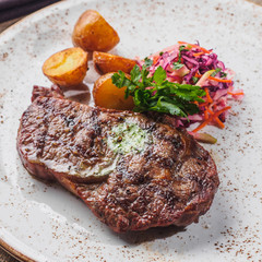 Beef steak with potato, salad cole slaw on the plate