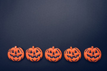 Dark background with halloween pumpkins.