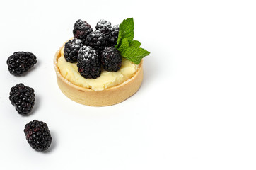 homemade Tart (tartlet) with blackberry and delicate cream of vanilla and mint