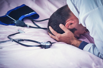 sad doctor on bed
