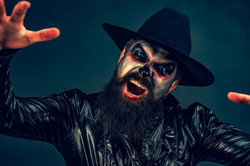 Scary Halloween man in hat - studio shot close-up. Halloween design with copy space. Happy...