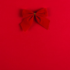 Bow on a red background, Christmas concept, copy space.