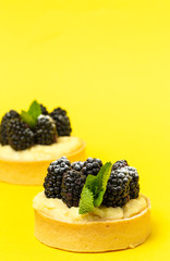 homemade Tart (tartlet) with blackberry and delicate cream of vanilla and mint