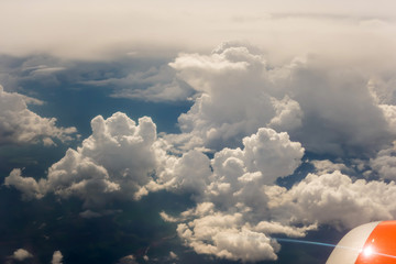Naklejka na ściany i meble wing of airplane flying turbine above clouds travel