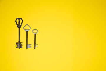 Keys on yellow background. Minimal creative style