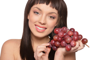 Portrait of young woman posing with grapes