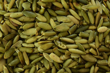 Heap of green pumpkin seeds background