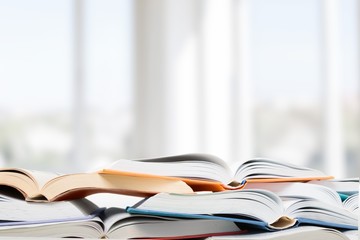 Colorful books collection on background.