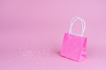 Paper shopping or gift bags  on pink background with copy spaсe. Concept sales, shopping, black friday. Giving gift for birthday, christmas and New Year. 