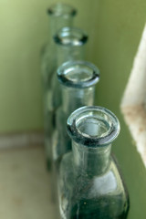 Tops of vintage bottles in window setting
