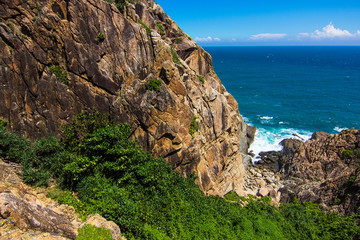 Beautiful rocks on the small Boundary island near Sanya, exotic Hainan island, China. Beautiful blue South China sea and green palm trees