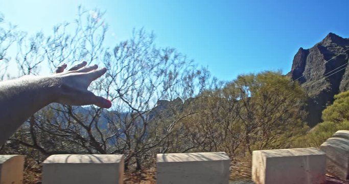 Hand Of Man Driving In Car Enjoying Stunning Tropical Nature Mountains Scenery Passing-by. Pov Shot Of Guy Admiring Freedom Travel On Tenerife Island.