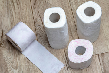 wooden background. toilet paper and some paper towels. close-up.