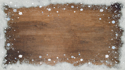 winter Background - Frame made of snow on wooden texture, top view with space for text